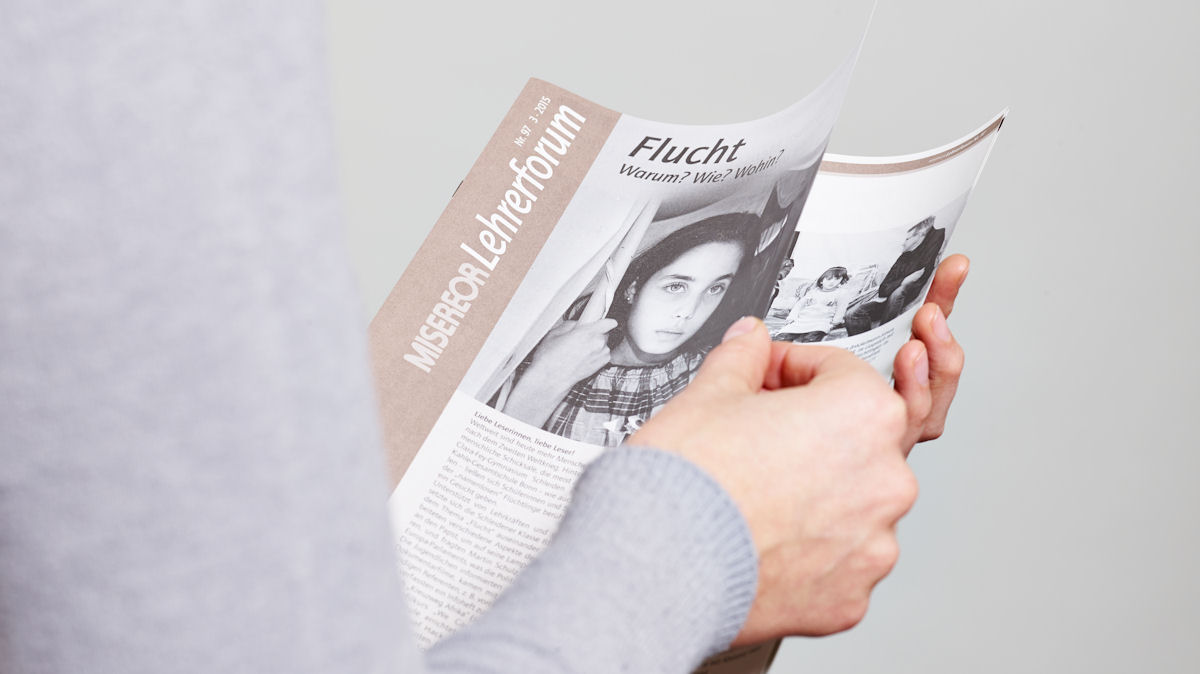 Eine Frau hält eine Zeitschrift in der Hand